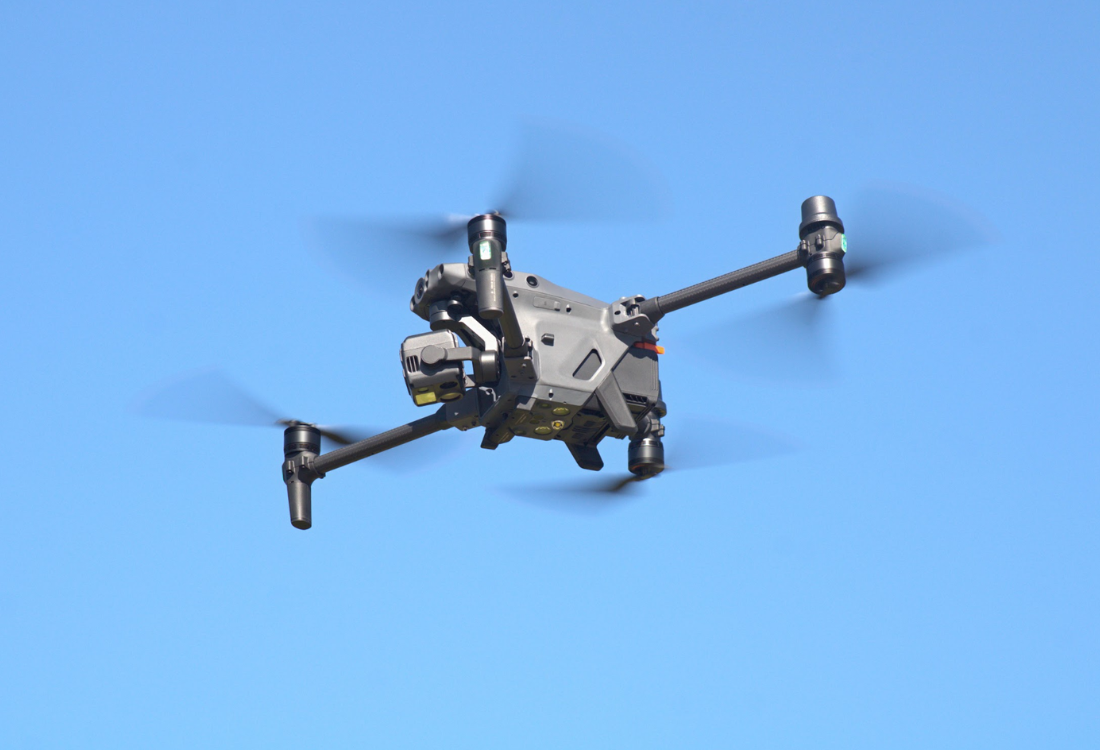 DJI Inspire 3 cinema drone in flight against a clear blue sky, considered the best DJI drone for filming television dramas and commercial productions.